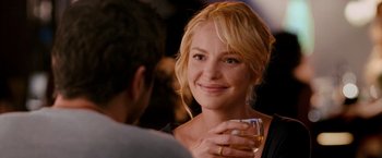Movie still from “The Ugly Truth” (2009), directed by Robert Luketic – A beautiful young lady holding a glass of wine; Close Up shot, Over the shoulder angle