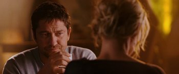 Movie still from “The Ugly Truth” (2009), directed by Robert Luketic – A person sitting at a table; Close Up shot, Over the shoulder angle