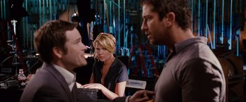 Movie still from “The Ugly Truth” (2009), directed by Robert Luketic – A group of people sitting around a table; Medium shot, Over the shoulder angle