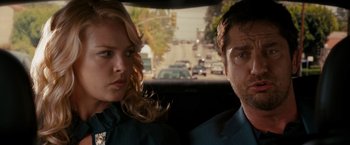 Movie still from “The Ugly Truth” (2009), directed by Robert Luketic – A man and a woman sitting in the back of a car; Close Up shot, Over the shoulder angle