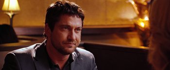 Movie still from “The Ugly Truth” (2009), directed by Robert Luketic – A person sitting in a room; Close Up shot, Over the shoulder angle