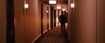 Movie still from “The Ugly Truth” (2009), directed by Robert Luketic – A man walking down a hallway in a building; Wide shot, High angle