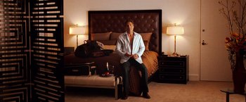 Movie still from “The Ugly Truth” (2009), directed by Robert Luketic – A man sitting on the edge of a bed in a hotel room; Medium shot, High angle