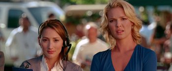 Movie still from “The Ugly Truth” (2009), directed by Robert Luketic – Two women wearing headphones and standing next to each other; Close Up shot, Low angle