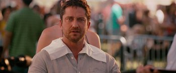 Movie still from “The Ugly Truth” (2009), directed by Robert Luketic – A person wearing a dress shirt; Close Up shot, Over the shoulder angle