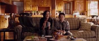 Movie still from “The Ugly Truth” (2009), directed by Robert Luketic – A woman and a boy sitting on a couch; Medium shot, Over the shoulder angle