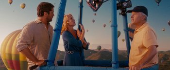 A woman standing next to a man on a ferris wheel