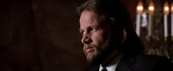 Movie still from “Enemy of the State” (1998), directed by Tony Scott – A man in a suit and tie looking to his left; Close Up shot, Low angle