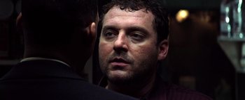 Movie still from “Enemy of the State” (1998), directed by Tony Scott – A person looking at the camera; Close Up shot, Low angle