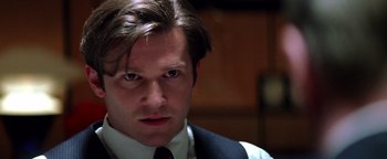 Movie still from “Enemy of the State” (1998), directed by Tony Scott – A person wearing a suit and tie; Close Up shot, Low angle