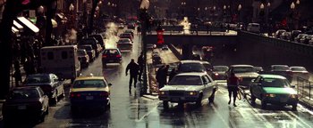 Movie still from “Enemy of the State” (1998), directed by Tony Scott – A busy city street filled with lots of traffic; Extreme Wide shot, High angle