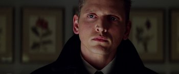 Movie still from “Enemy of the State” (1998), directed by Tony Scott – A person wearing a suit and tie; Close Up shot, Low angle