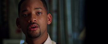 Movie still from “Enemy of the State” (1998), directed by Tony Scott – A man's face in a white shirt; Close Up shot, Over the shoulder angle