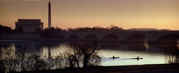 Movie still from “Enemy of the State” (1998), directed by Tony Scott – A person in a boat on a body of water; Extreme Wide shot, High angle