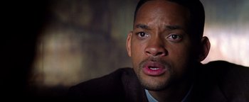 Movie still from “Enemy of the State” (1998), directed by Tony Scott – A man's face as he stares into the distance; Close Up shot, High angle