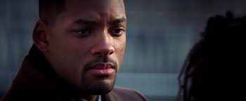 Movie still from “Enemy of the State” (1998), directed by Tony Scott – A man's face in a brown jacket; Close Up shot, Over the shoulder angle