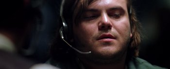 Movie still from “Enemy of the State” (1998), directed by Tony Scott – A person wearing a headset; Close Up shot, Low angle