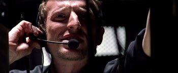 Movie still from “Enemy of the State” (1998), directed by Tony Scott – A person with a microphone in his mouth; Close Up shot, Low angle
