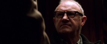 Movie still from “Enemy of the State” (1998), directed by Tony Scott – An older man wearing glasses looking into a mirror; Close Up shot, Low angle