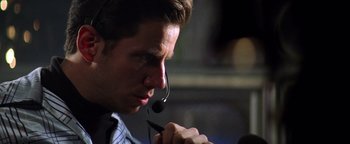 Movie still from “Enemy of the State” (1998), directed by Tony Scott – A person wearing a headset; Close Up shot, Low angle