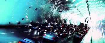 Movie still from “Enemy of the State” (1998), directed by Tony Scott – A bunch of cars driving down a street in a tunnel; Extreme Wide shot, High angle
