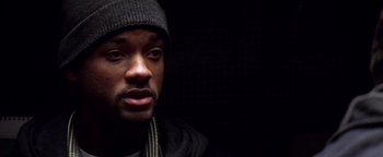 Movie still from “Enemy of the State” (1998), directed by Tony Scott – A person wearing a hat; Close Up shot, Over the shoulder angle