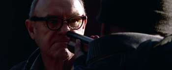 Movie still from “Enemy of the State” (1998), directed by Tony Scott – An older man wearing glasses and a hat is looking at a younger man; Close Up shot, Over the shoulder angle
