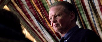 Movie still from “Enemy of the State” (1998), directed by Tony Scott – An older man is looking at the camera; Close Up shot, Low angle