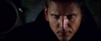 Movie still from “Enemy of the State” (1998), directed by Tony Scott – A man's face in the dark; Close Up shot, Low angle