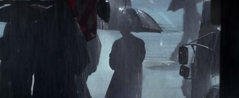 Movie still from “Enemy of the State” (1998), directed by Tony Scott – A person holding an open umbrella in the rain; Extreme Close Up shot, High angle