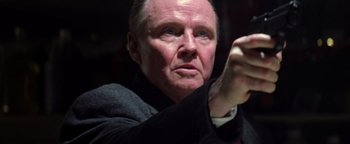 Movie still from “Enemy of the State” (1998), directed by Tony Scott – An older man is holding something in his right hand; Close Up shot, Low angle