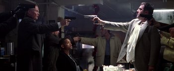 Movie still from “Enemy of the State” (1998), directed by Tony Scott – A group of men holding guns in a room; Medium shot, Low angle