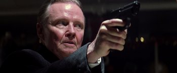 Movie still from “Enemy of the State” (1998), directed by Tony Scott – An older man holding a gun in his right hand; Close Up shot, Low angle