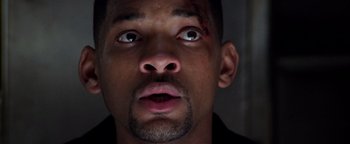 Movie still from “Enemy of the State” (1998), directed by Tony Scott – A person with a scar on his face; Close Up shot, Low angle