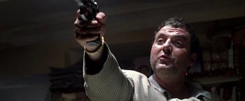 Movie still from “Enemy of the State” (1998), directed by Tony Scott – A person holding a gun in his hand; Close Up shot, Low angle