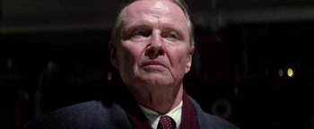 Movie still from “Enemy of the State” (1998), directed by Tony Scott – An older man wearing a suit and a tie; Close Up shot, Low angle