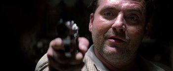 Movie still from “Enemy of the State” (1998), directed by Tony Scott – A person holding a gun; Close Up shot, Low angle