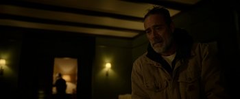 Movie still from “The Unholy” (2021), directed by Evan Spiliotopoulos – A man in a brown jacket is standing in a dimly - lit room; Close Up shot, Over the shoulder angle