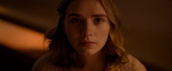 Movie still from “The Unholy” (2021), directed by Evan Spiliotopoulos – A woman's face in a dimly - lit room; Close Up shot, Low angle