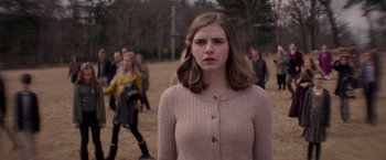 Movie still from “The Unholy” (2021), directed by Evan Spiliotopoulos – A woman standing in front of a group of people; Medium shot, Over the shoulder angle