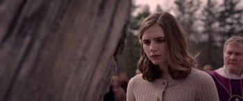 Movie still from “The Unholy” (2021), directed by Evan Spiliotopoulos – A young woman is standing in front of a tree; Close Up shot, Over the shoulder angle