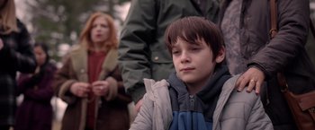 Movie still from “The Unholy” (2021), directed by Evan Spiliotopoulos – A young boy sitting in front of an older woman; Close Up shot, Over the shoulder angle