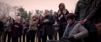 Movie still from “The Unholy” (2021), directed by Evan Spiliotopoulos – A group of people standing in a field; Medium shot, Over the shoulder angle