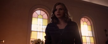 Movie still from “The Unholy” (2021), directed by Evan Spiliotopoulos – A woman standing in front of a stained - glass window; Medium shot, Low angle