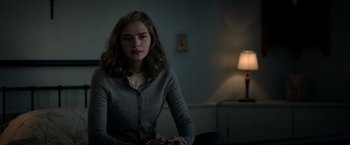 Movie still from “The Unholy” (2021), directed by Evan Spiliotopoulos – A woman sitting on a couch in front of a lamp; Close Up shot, Over the shoulder angle