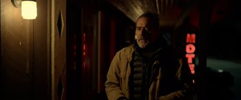 Movie still from “The Unholy” (2021), directed by Evan Spiliotopoulos – A man with a beard wearing a brown jacket; Close Up shot, Over the shoulder angle