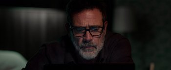 Movie still from “The Unholy” (2021), directed by Evan Spiliotopoulos – An older man wearing glasses looking at a computer screen; Close Up shot, Over the shoulder angle