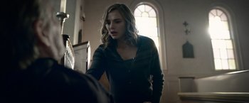 Movie still from “The Unholy” (2021), directed by Evan Spiliotopoulos – A woman standing next to a man in a room; Medium shot, Over the shoulder angle