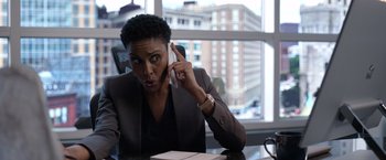 Movie still from “The Unholy” (2021), directed by Evan Spiliotopoulos – A woman sitting at a table talking on a phone; Close Up shot, Over the shoulder angle