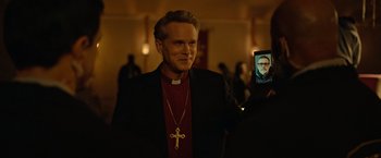 Movie still from “The Unholy” (2021), directed by Evan Spiliotopoulos – A man holding a cell phone in front of his face; Close Up shot, Over the shoulder angle